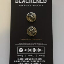 Back of the packaging of Bottle Of Blackened Enamel Pin