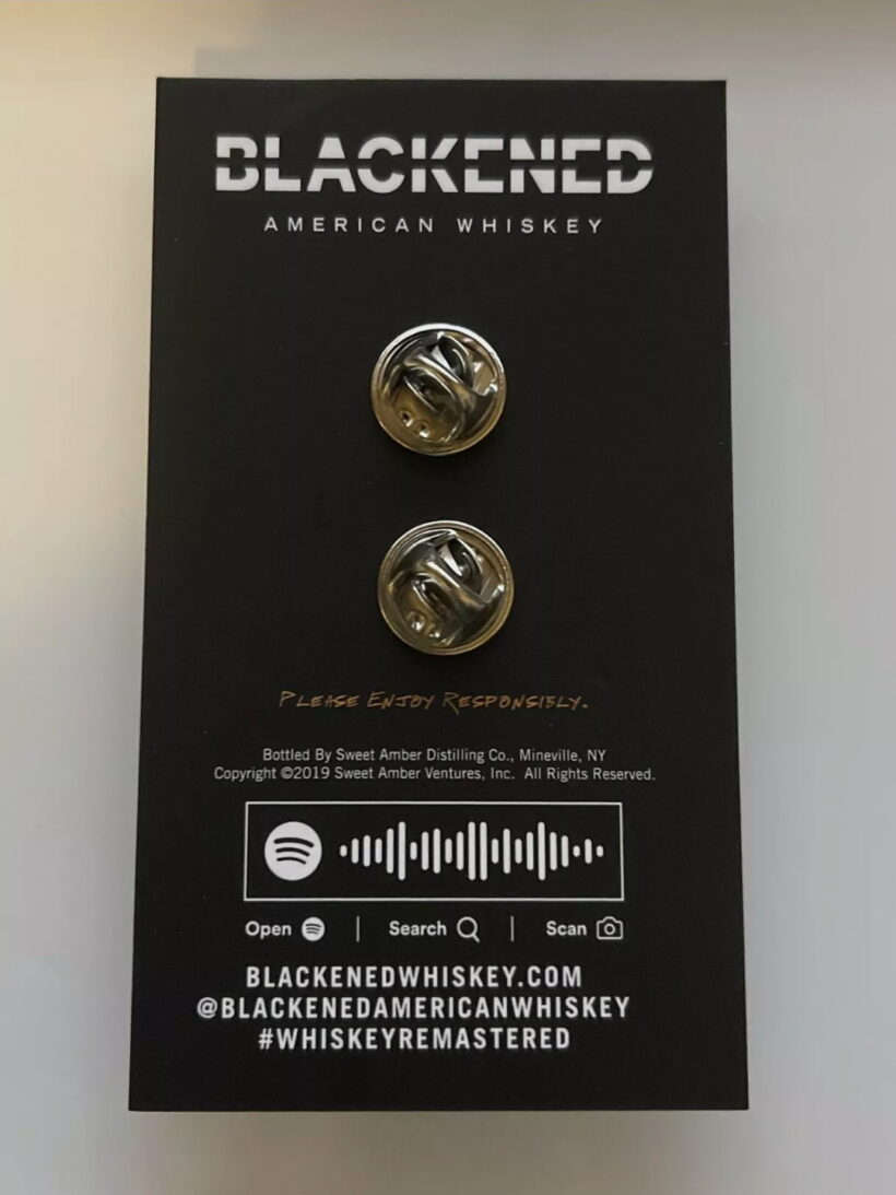 Back of the packaging of Bottle Of Blackened Enamel Pin