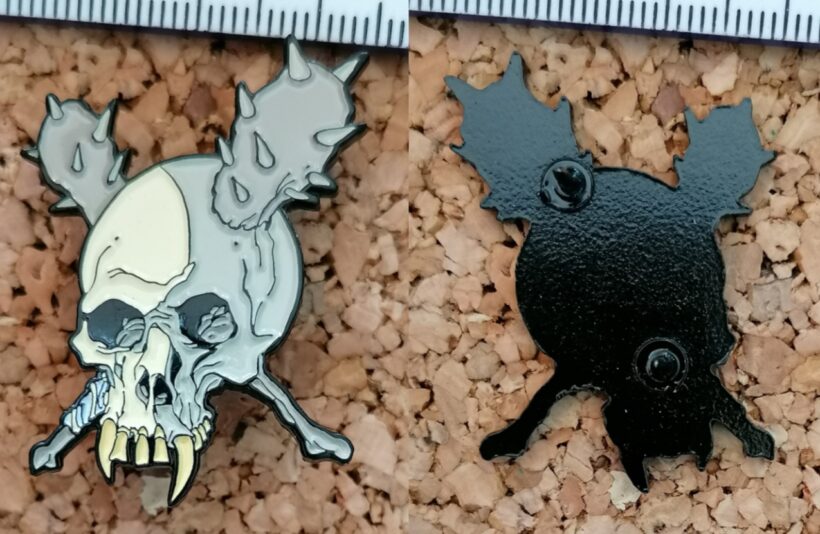 Second picture of X Second picture of Damage Inc. Enamel Pin
