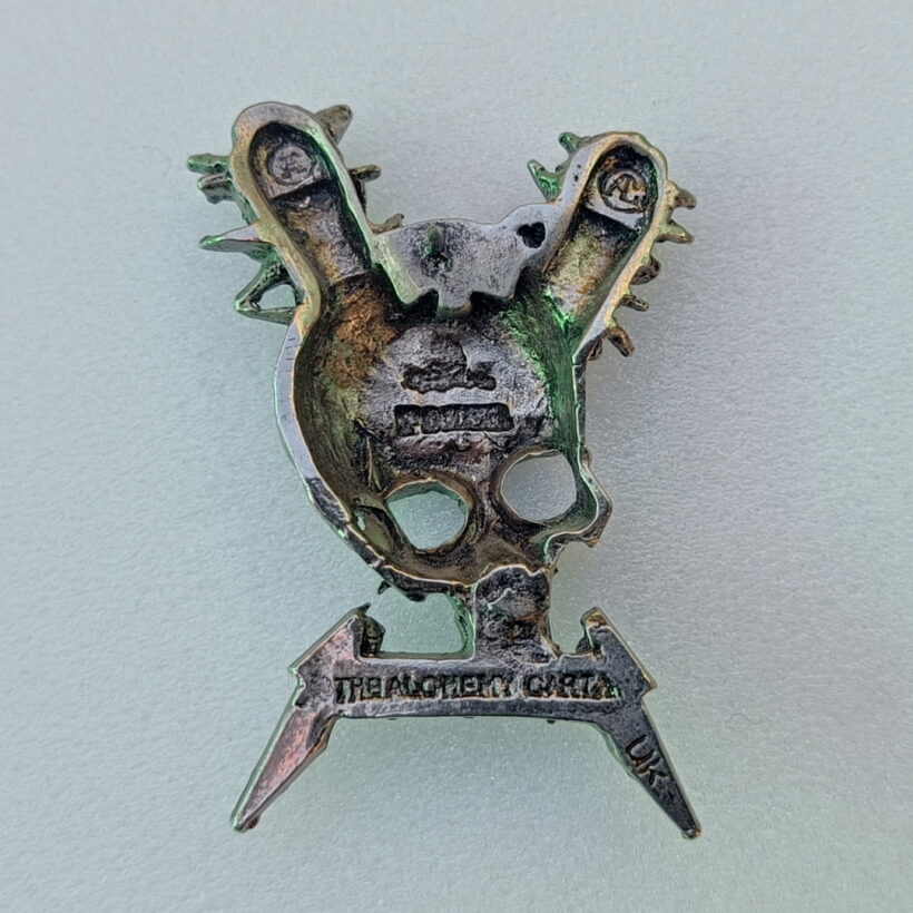 Back of Damage Inc. Pewter Pin